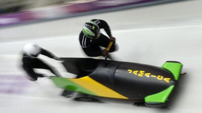 Pilot Winston Watts of Jamaica and his push athlete Marvin Dixon at the start of their run in the men's two-man bobsleigh training session on Friday. Tobias Hase / EPA
