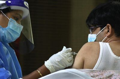 A man receives his Covid-19 vaccine at Guru Nanak Darbar temple in Dubai. Kamran Jebreili / AP Photo