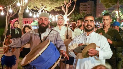 A musaharati drummer passes through the crowds at the Ramadan Village, Tripoli. Photo: Olivia Cuthbert