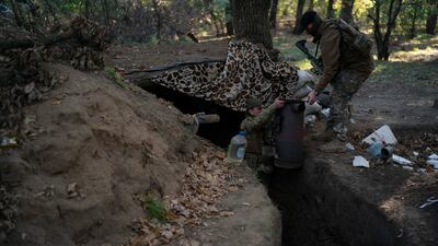 Ukrainian troops check trenches that had been dug by Russian soldiers, in a retaken area of Kherson region in southern Ukraine. AP
