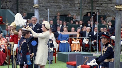 Queen Elizabeth II crowns her son Charles, then Prince of Wales, during his investiture ceremony on July 1, 1969 at Caernafon Castle in Wales. Prince Philip the Duke of Edinburgh is seated at right. AP