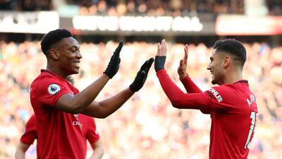 Andreas Pereira celebrates with Anthony Martial after scoring his team's first goal on Sunday. Getty Images