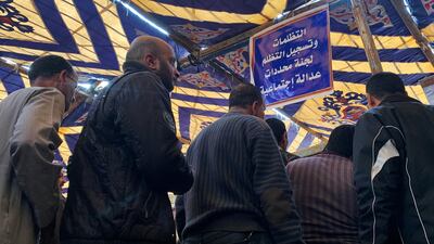 Egyptians line up in a tent, to submit complaints about the latest subsidy reforms in a suburb of Cairo, Egypt March 28, 2019. All Egyptian workers and pensioners are set to get a pay rise. Reuters