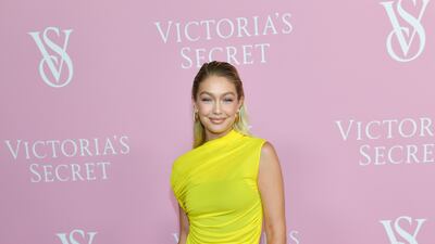 Gigi Hadid bucks the dress code, arriving in a semi-sheer dress in dazzling chartreuse. AP