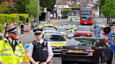 Police officers at the scene where two Jewish men are seriously injured after being stabbed in Golders Green. EPA