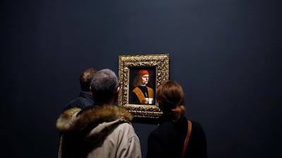 Journalists watch the painting "Portrait of a Musician" by Leonardo Da Vinci, at the Louvre museum, in Paris. AP