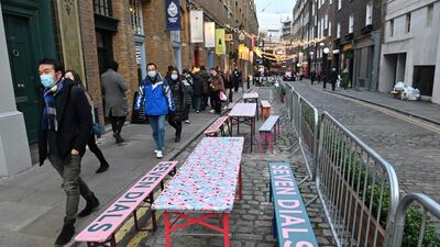 Empty tables outside a restaurant in the Seven Dials district of London. Covid-19 infections have surged in recent days, authorities say. AFP