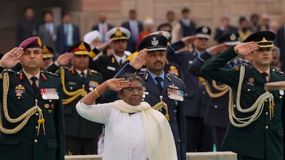 Ms Murmu salutes during tributes to Gandhi in New Delhi. AP