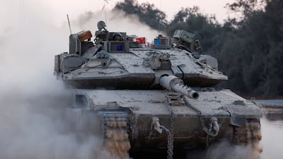 An Israeli tank returns from the Gaza Strip. Israel has launched further attacks on southern and central areas of the besieged enclave. Reuters