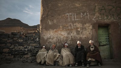 Amazigh villagers rest as the sun sets on February 4, 2016, in a village near Midelt, a town in central Morocco, between the Middle and High Atlas mountains.