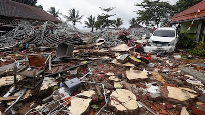 A view of damage with a car sitting among debris in Tanjung Lesung. EPA