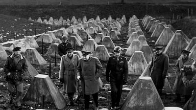 Winston Churchill walking among the 'dragon teeth', the lines of tank defences, of the Siegfried Line during his visit to the 9th Army in Germany, circa 1945. He is accompanied by Field Marshal Bernard Montgomery and Sir Alan Brooke, Chief of the Imperial General Staff. Getty Images