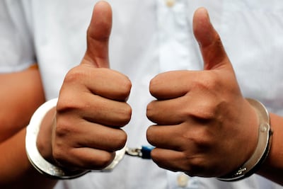 Reuters journalist Wa Lone gives the thumbs up in Insein court in Yangon, Myanmar, September 3, 2018. Reuters