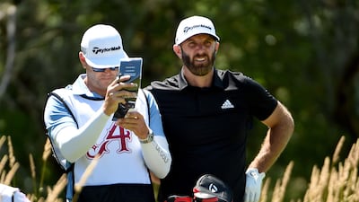 Dustin Johnson and his caddie wait to hit on the seventh hole during round two of the LIV Golf Invitational - Portland. Getty