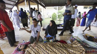 Patients are given medical treatment in the corridor of a hospital after the earthquake struck Pidie Jaya district. Hotli Simanjuntak / EPA
