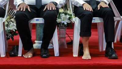 Parishioners at St Joseph's Cathedral, during a ritual Easter service featuring washing of the feet. Victor Besa / The National