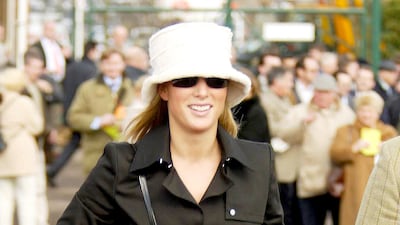 Zara Phillips, wearing a black coat, thigh-high boots and a bucket hat, attends the Cheltenham Gold Cup on March 18, 2004. Getty Images