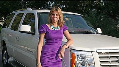 Lea-Ann Randall, a business development manager in Dubai, pictured with her 2005 pearl white Cadillac Escalade. Ms Randall bought the SUV 18 months ago from a friend.