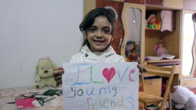 Syrian Bana Al Abed, who with the help of her mother had been posting heartrending tweets in English on life in the besieged eastern districts of Syria’s Aleppo, prepares a placard on October 10, 2016. Thaer Mohammed / AFP