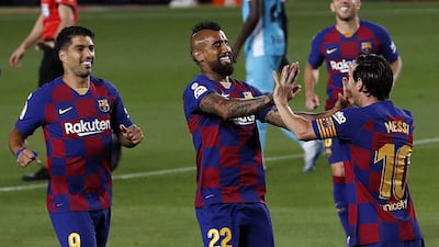 Lionel Messi celebrates with Arturo Vidal and Luis Suarez after scoring the second goal against Leganes at Camp Nou. EPA