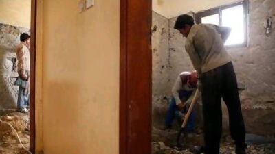 Workers demolish the inside of houses in Sharjah.