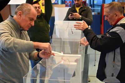 Officials seal the ballot boxes with wax as they prepare to open a polling station in Belgrade on April 3. AFP