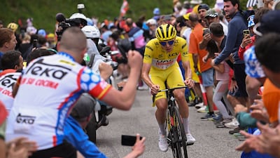 Tadej Pogacar is cheered on to victory on Stage 14. AP