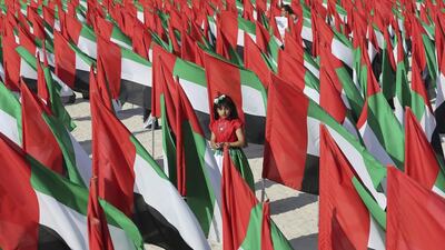 An Emirati girl walks inside the Flags Garden featuring 4,000 UAE flags in Dubai. Kamran Jebreili / AP Photo