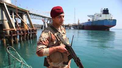 An Iraqi navy stands guard while an oil tanker loads crude oil at the Al Basra offshore terminal. AP Photo