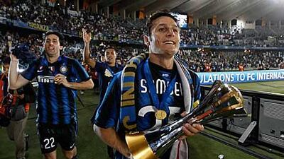 Javier Zanetti, the Inter Milan captain, holds the Club World Cup trophy as the players perform a lap of honour around Zayed Sports City.