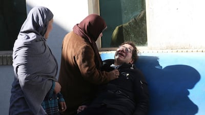 Two women console a man outside a hospital following a suicide attack in Kabul, Afghanistan. Rahmat Gul / AP Photo