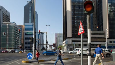 Pedestrians crossing Hamdan Street intersection in Abu Dhabi. Mona Al Marzooqi / The National