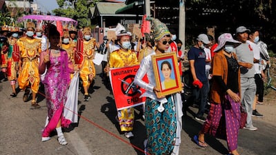 Protesters hold up an image of Aung San Suu Kyi and signs as they demonstrate against the military coup in Myeik, Tanintharyi region. AFP