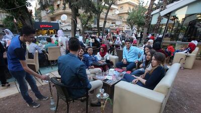 Syrian youths at a cafe in the government-held area of the northern Syrian city of Aleppo as they celebrate the Eid al-Adha Muslim holiday on September 13, 2016, a day after a fragile ceasefire was brokered. Youssef Karwashan / AFP