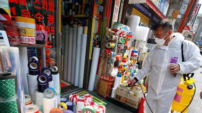 An member of a quarantine team sprays disinfectant as a preventive measure against coronavirus in Bangsan Market in Seoul. EPA