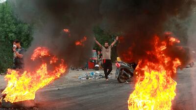 Anti-government protesters set fires and close a street during a demonstration in Baghdad, Iraq on Thursday, Oct. 17, 2019. AP