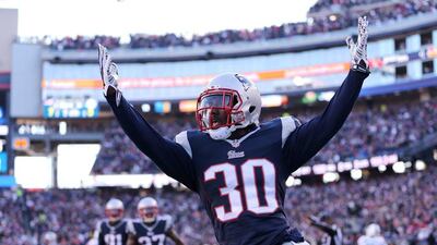 New England Patriots defensive back Duron Harmon celebrates after an interception returned for a touchdown on Sunday in his team's NFL win against the Dolphins. Matt Campbell / EPA / December 14, 2014