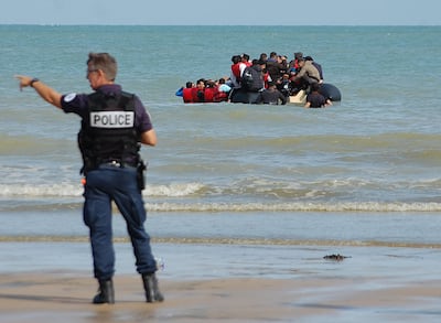 A French police officer during an attempt to stop migrants trying to illegally cross the Channel to Britain. AFP