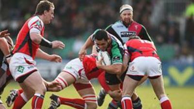 Tani Fuga of the Harlequins tries to break through the Scarlets defence in their Heineken Cup match yesterday.