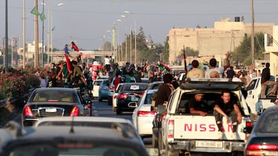 Libyan rebel fighters and civilians ride through the town of Maia celebrating after rebels pushed to within 25 kms (15 miles) of Tripoli, August 21, 2011. REUTERS/Bob Strong