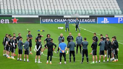Real Madrid manager Carlo Ancelotti (in baseball cap, centre) instructs his side during their Monday training session for Tuesday's Champions League semi-final first leg in Turin against Juventus. Alessandro Di Marco / EPA