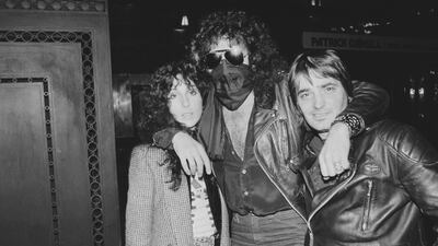 Cher, in an oversized blazer, with Gene Simmons, centre, on April 11, 1978. Getty Images