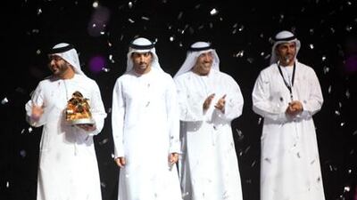 Sheikh Hamdan bin Mohammed bin Rashid al Maktoum, Crown Prince of Dubai presents the grand prize to Emirati photographer, Osama al Zubeidi (L) at the Hamdan International Photography Awards in Dubai. Ravindranath K / The National