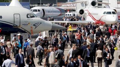 Visitors walk at the static display area during the 51st Paris Air Show at Le Bourget airport. Pascal Rossignol / Reuters