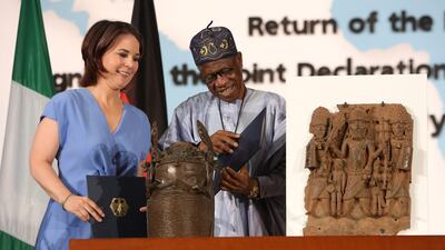 Nigerian Culture Minister Layiwola Mohammed and German Foreign Minister Annalena Baerbock sign agreement to return bronzes to Nigeria. AFP
