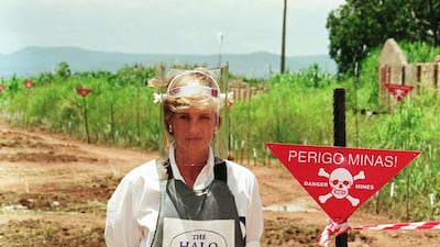 Princess Diana walks with body armour and a visor on the minefields during a visit to Angola in 1997. Getty Images