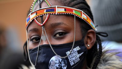 A demonstrator wearing a Cop26-themed mask attends the Fridays for Future march. Reuters