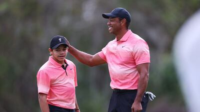 Tiger Woods and Charlie Woods celebrate on the seventh green during the first round of the PNC Championship. AFP