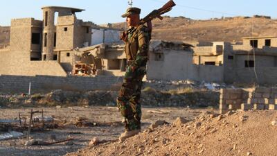 A peshmerga fighter takes in the destruction in Sinjar. ISIL holds towns nearby and must be fought, leaders say. Florian Neuhof for The National