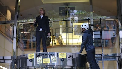 Gail Bradbrook, co-founder of Extinction Rebellion, speaks before smashing a window at the front of the building housing the government's Department for Transport. AFP